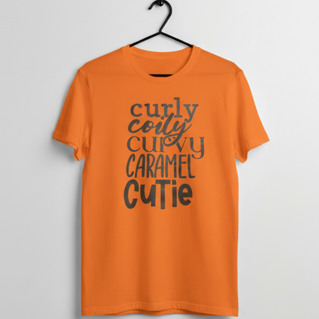 Orange graphic t shirt with text that reads curly coily curvy caramel cutie
