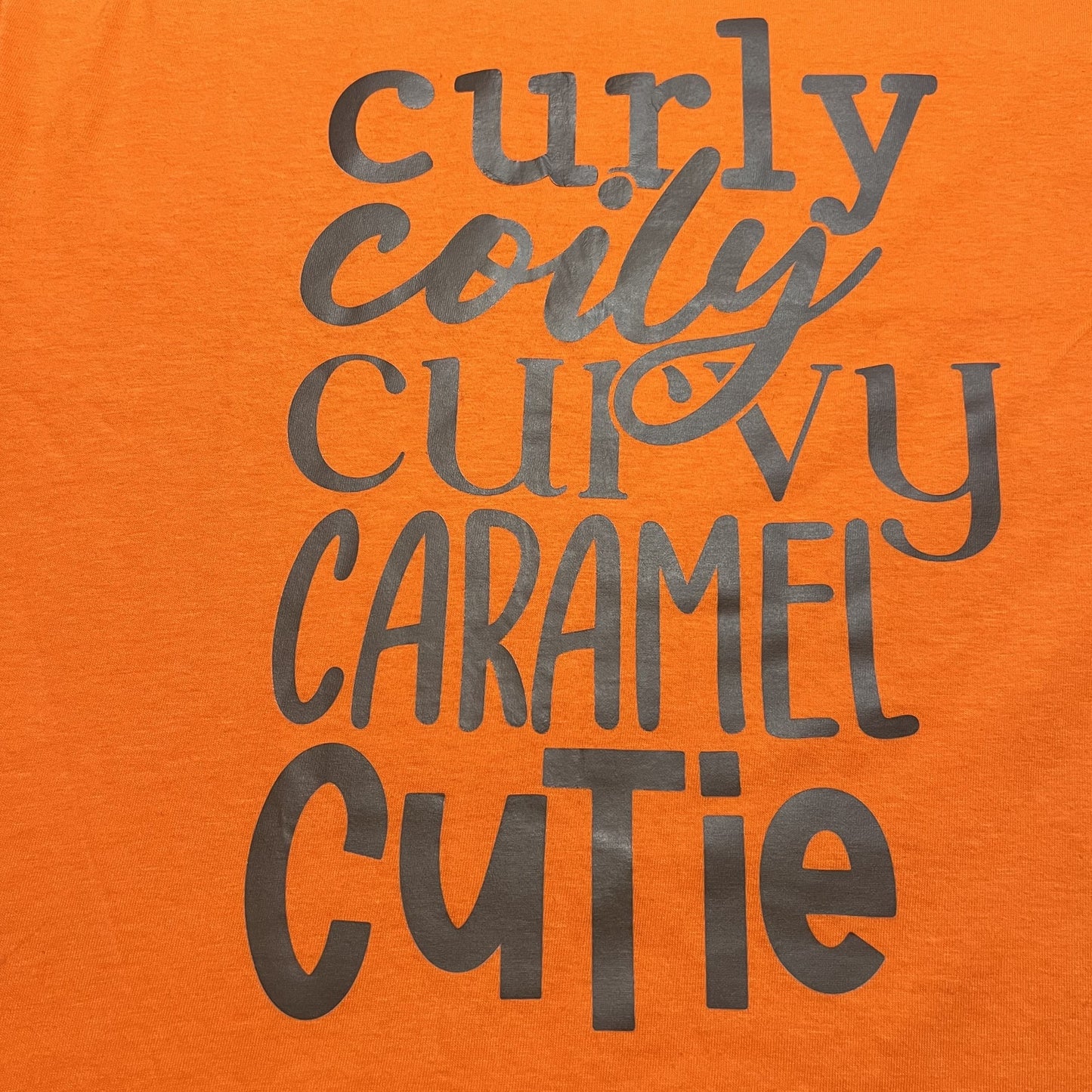 Orange graphic with text that reads curly coily curvy caramel cutie