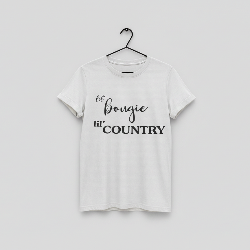 White t-shirt with 'lil' bougie hi' COUNTRY' text on a hanger against a light gray background