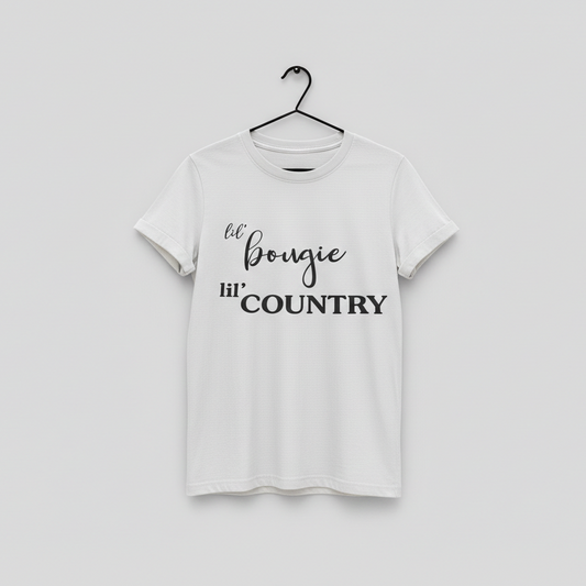 White t-shirt with 'lil' bougie hi' COUNTRY' text on a hanger against a light gray background